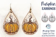 the pumpkin earrings are hand painted with acrylic paint and have ornate designs on them