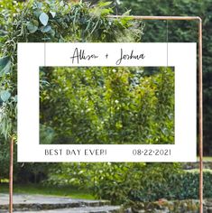 a wedding photo frame with greenery on it