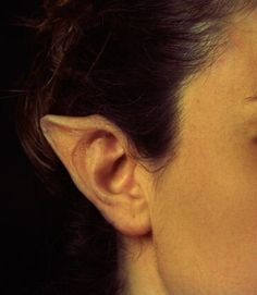 a close up of a woman's face and ear