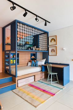 a child's bedroom with bunk beds and desks