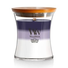 the woodwick candle holder is made from clear glass and has a wooden lid on it