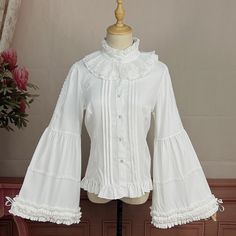 This price is for a shirt only, others are not included. Collar:Ruff CollarDress / Top Details:Front Button Placket / Lace Trim / Pleating Details / Ruffle TrimMaterial:Cotton / PolyesterSleeves:Balloon Sleeves / Bell Sleeves / Tie Closures Cuffs Size S M L XL 2XL Shoulders 35 36 37.5 39 40.5 Bust 84 88 92 96 100 Waist 70 74 78 82 86 Sleeve Length 59 60 61 62 63 ... Fitted White Shirt With Ruffles, White Collared Shirt With Ruffles, Classic Long Sleeve Shirt With Ruffles, White Cotton Shirt With Ruffled Collar, White Ruffled Collared Shirt, White Classic Top With Ruffled Collar, Fitted White Shirt With Ruffled Collar, White Fitted Shirt With Ruffled Collar, Classic White Top With Ruffled Collar