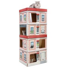 a cat is sitting on top of a doll house that has windows and balconies