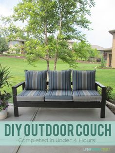 two couches sitting on top of a patio next to a tree and grass field