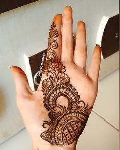 a woman's hand with henna on it