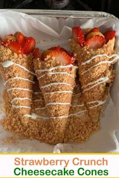 strawberry crumb cheesecake cones with strawberries on top in a tin foil container