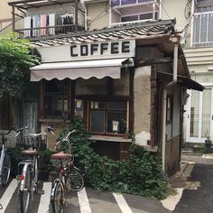 two bicycles are parked in front of a coffee shop