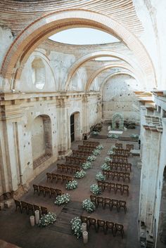 an old building with tables and chairs in it