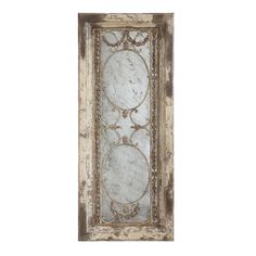 an old mirror with ornate designs on it's sides, hanging from the wall