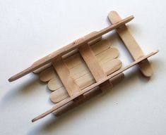 a wooden toy boat with paddles attached to it