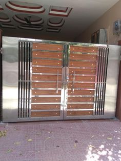 a large metal gate with wooden slats