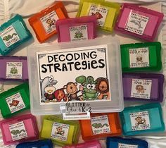 a bunch of different colored plastic containers with labels on them that say decoding strategies