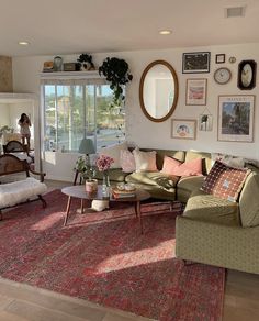 a living room filled with lots of furniture next to a large window covered in pictures