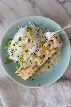 a blue plate topped with rice and meat