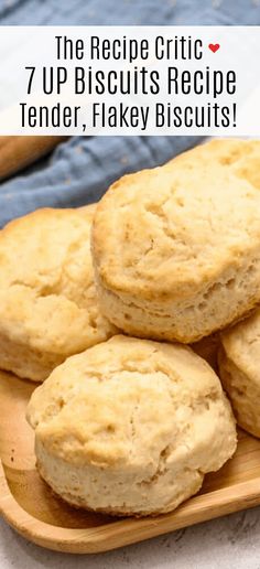 some biscuits are on a wooden plate with the words 7 up biscuits recipe tender, flaky biscuits