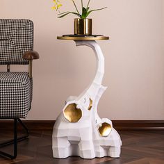 a giraffe shaped table next to a chair