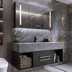 a bathroom with grey marble walls and flooring, including a sink, mirror, toilet and shower