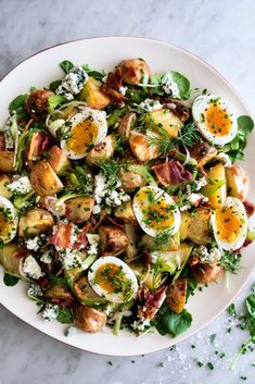 a white plate topped with potato salad and hard boiled eggs