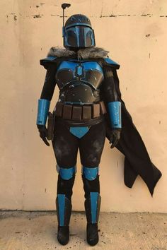 a man in a star wars costume standing next to a wall