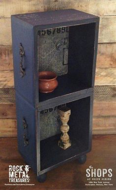 an old wooden cabinet with two shelves on wheels and a bowl in the bottom shelf