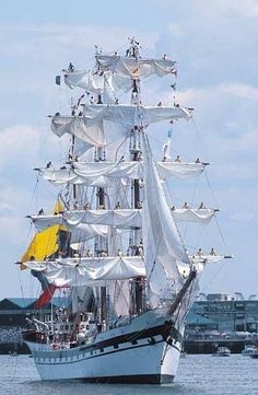 a large white sail boat in the water