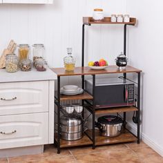 a kitchen with white walls and wooden shelves filled with pots, pans, and other items