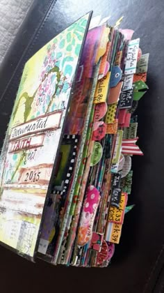 a close up of an open book on a leather chair with many pages stacked in it