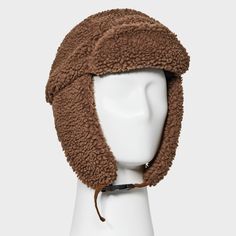 Take on the winter season in style with this Polyester All Over Faux Shearling Trapper Hat from Goodfellow & Co™. Made from a heavyweight woven fabric and filling, this faux shearling trapper hat offers your head and ears all-day cozy comfort. Designed with a chinstrap hook-and-loop fastener for a snug fit, it makes a standout addition to your collection of winterwear. Goodfellow & Co™: Feel good in what you wear, anywhere. Brown Hats With Fleece Lining For Cold Weather, Brown Insulated Winter Hat, Brown Aviator Winter Hats, Brown Winter Hats, Winter Brown Aviator Hats, Brown Hat With Plush Lining For Cold Weather, Winter Aviator Hat With Plush Lining, Fall Hats With Faux Fur Lining And Ear Flaps, Brown Faux Fur Hats For Outdoor