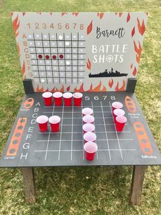 a board game set up with cups on it for an outdoor barbeque party