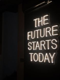 a neon sign that says the future starts today