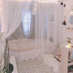 a bedroom with white curtains and lights on the ceiling