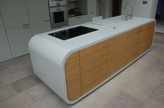 a large white counter top sitting inside of a kitchen