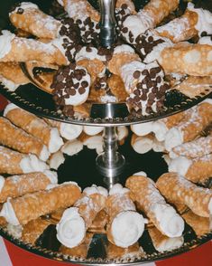 two tiered trays filled with pastries on top of a table