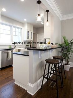 a kitchen with an island and two stools