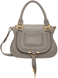 Grained calfskin shoulder bag in gray. · Twin rolled carry handles · Detachable and adjustable shoulder strap · Concealed patch pocket and logo embossed at face · Foldover flap with pull-through fastening at face · Zip closure · Zip pocket at interior · Cotton twill lining · H9 x W12 x D3.5 Supplier color: Cashmere gray | Chloé Gray Marcie Shoulder Bag Chloe Clothing, Brown Shoulder Bag, How To Have Twins, Chloe Marcie, Leather Logo, Handle Bag, Embossed Logo, Green Gold, Leather Working