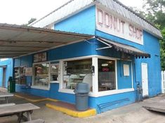 a blue building with a donut shop on the front