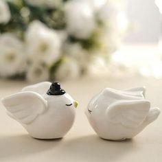 two white ceramic birds sitting next to each other