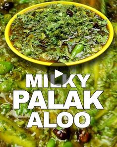 a yellow bowl filled with lots of green food next to a white and black sign that says mix palak aloo