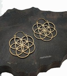 HANDMADE Beautiful Ethnic sacred geometry flower of life hoop earrings. The Flower of Life is a sacred power symbol of the connections life weaves through all beings. It is believed to contain the patterns of creation and fundamental forms of space and time.  Beautiful detailed handmade earrings , ideal for any look. SIZE Aprox Length: 5 cm Aprox width: 4.3 cm Handmade with high quality hypoallergenic Jewelery brass, nickel free. Please follow the link to view my shop for other beautiful pieces. Spiritual Hoop Earrings, Spiritual Hoop Earrings For Festivals, Sacred Geometry Flower Of Life, Hippie Chic Jewelry, Sacred Geometry Jewelry, Boho Hoop Earrings, Large Statement Earrings, Beautiful Anklet, Statement Hoop Earrings