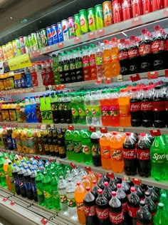 many different types of sodas are on display in a grocery store, and there is no image here to provide a caption for