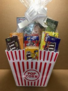 a popcorn bucket filled with snacks and candy