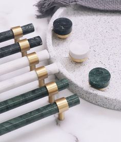 marble and brass knobs are arranged on a marble tray