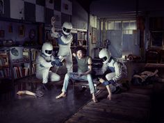 four people in white suits sitting on a couch