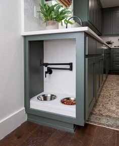 a dog bowl in the corner of a kitchen