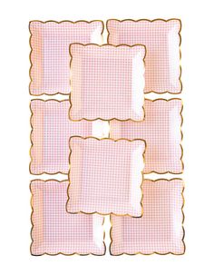 four pink squares with gold trims on them