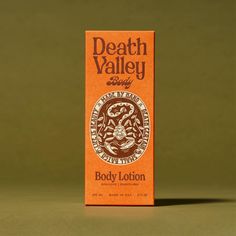 a box of body lotion sitting on top of a green table next to a brown wall