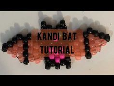 the words kandi bat are written in black and pink