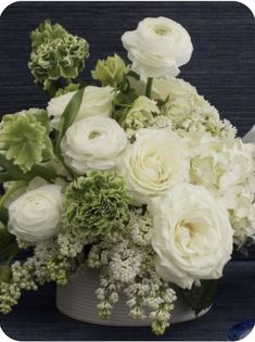 a bouquet of white flowers in a gray vase