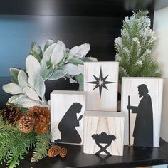 wooden blocks decorated with nativity images and pine cones