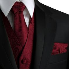 a man in a black suit and red tie